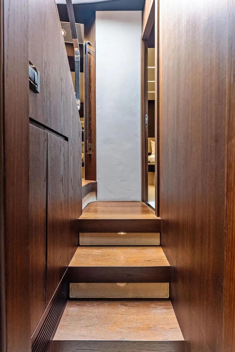 Slide: The Image of Wooden staircase inside 2017 Azimut 72 Flybridge yacht, leading to interior cabin. - 48