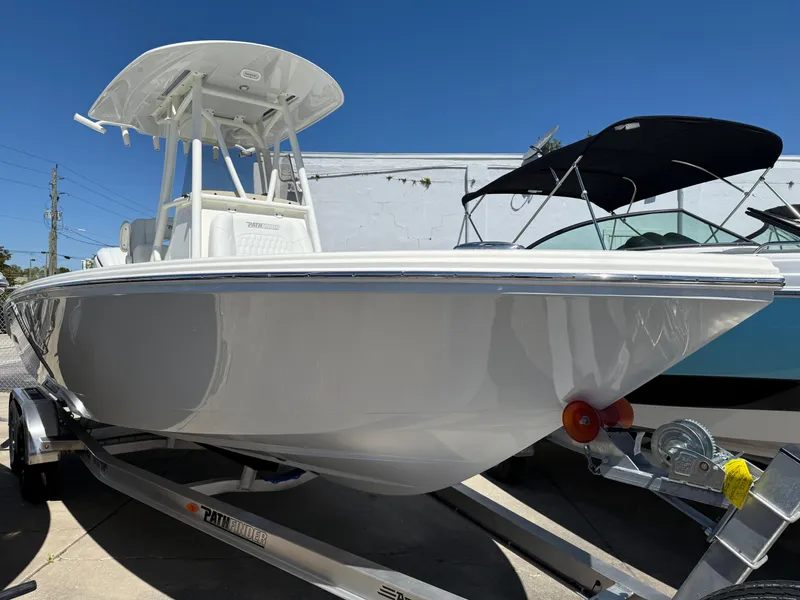 Slide: The Image of 2025 Pathfinder 2400 Open boat on trailer under clear blue sky. - 4