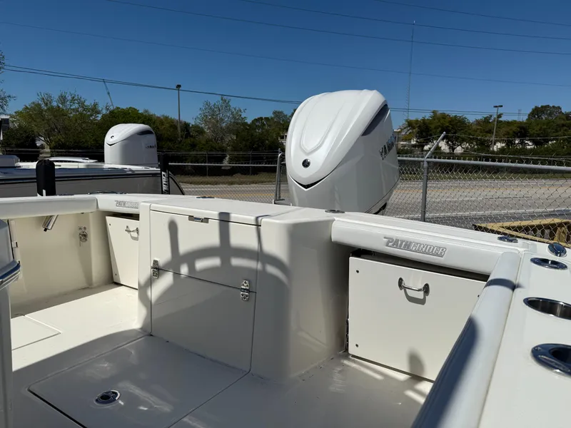 Slide: The Image of 2025 Pathfinder 2400 Open boat interior with storage compartments and outboard motor. - 8