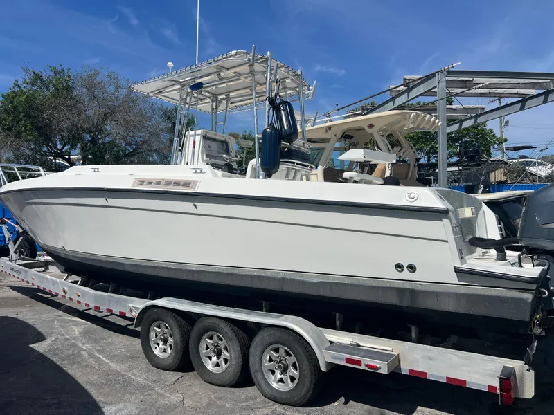 Slide: The Image of 1999 Contender 35 Center Console boat with forward cuddy on a trailer. - 1