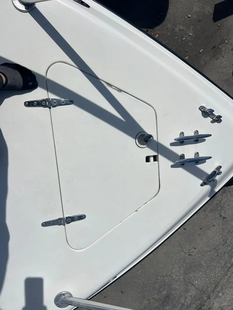 Slide: The Image of 1999 Contender 35 Center Console boat deck with forward cuddy hatch and cleats. - 14