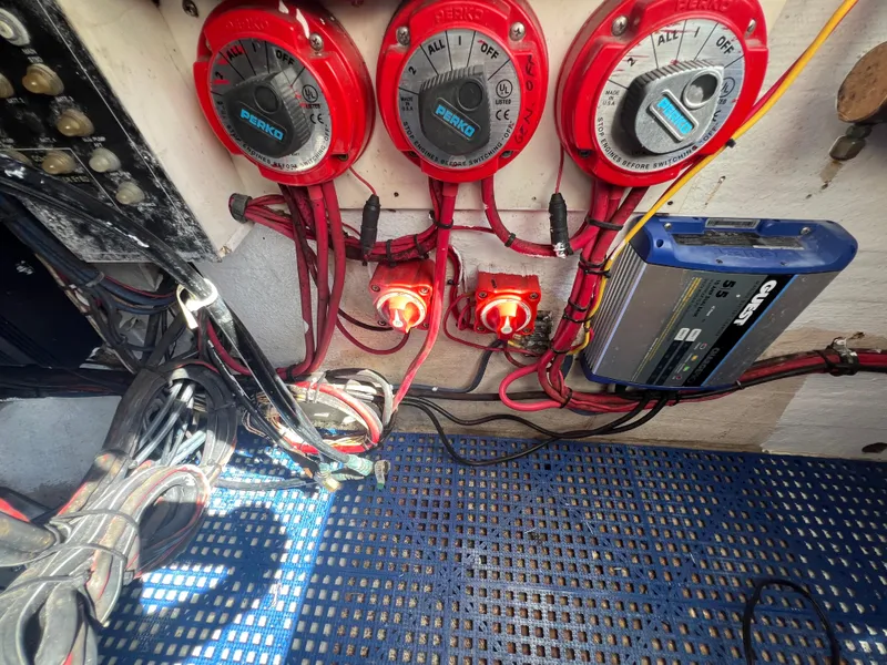 Slide: The Image of Electrical panel of a 1999 Contender 35 Center Console boat with battery switches and wiring. - 16