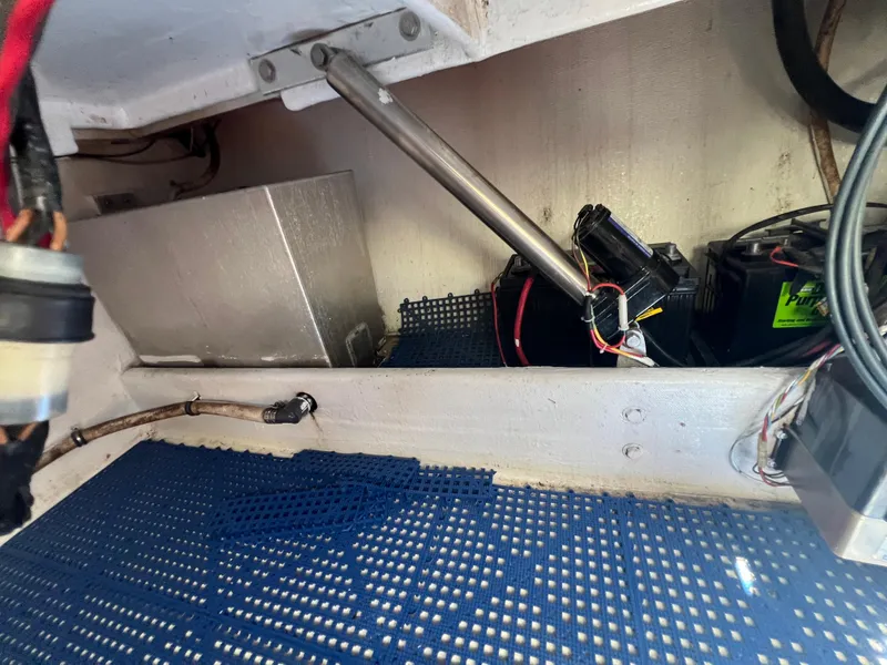 Slide: The Image of 1999 Contender 35 Center Console interior with mechanical components and wiring. - 17