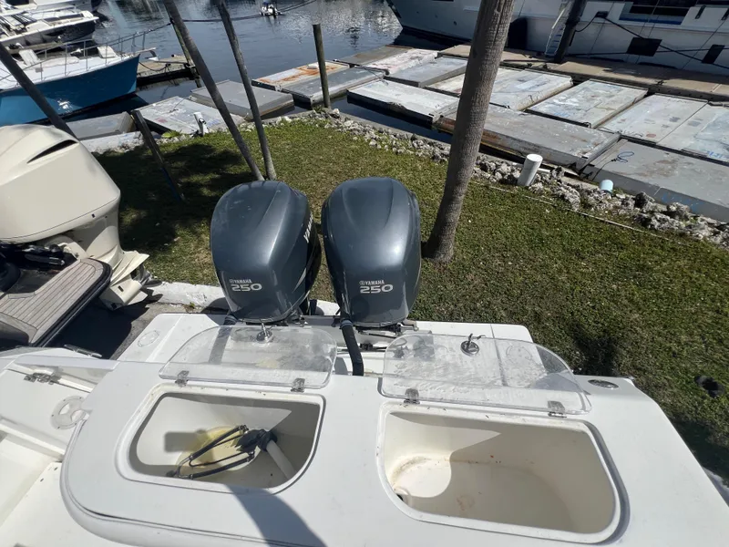 Slide: The Image of 1999 Contender 35 Center Console boat with twin 250 horsepower engines at a marina. - 20