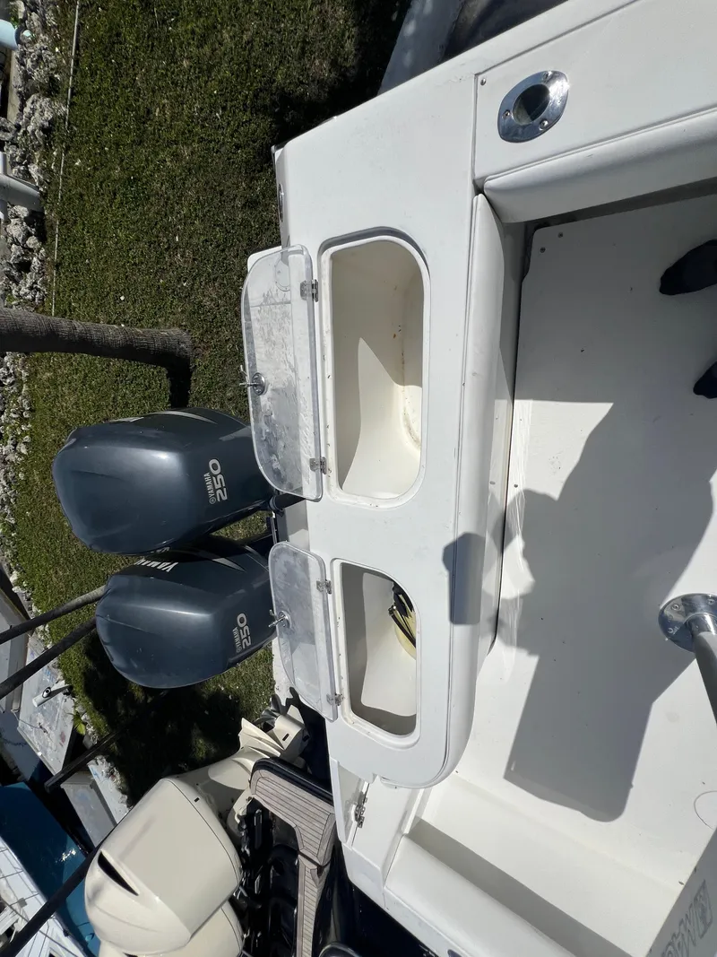 Slide: The Image of 1999 Contender 35 Center Console boat with twin outboard engines, featuring a forward cuddy. - 21