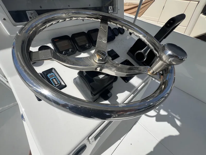 Slide: The Image of 1999 Contender 35 Center Console helm with stainless steel steering wheel and instrument panel. - 23