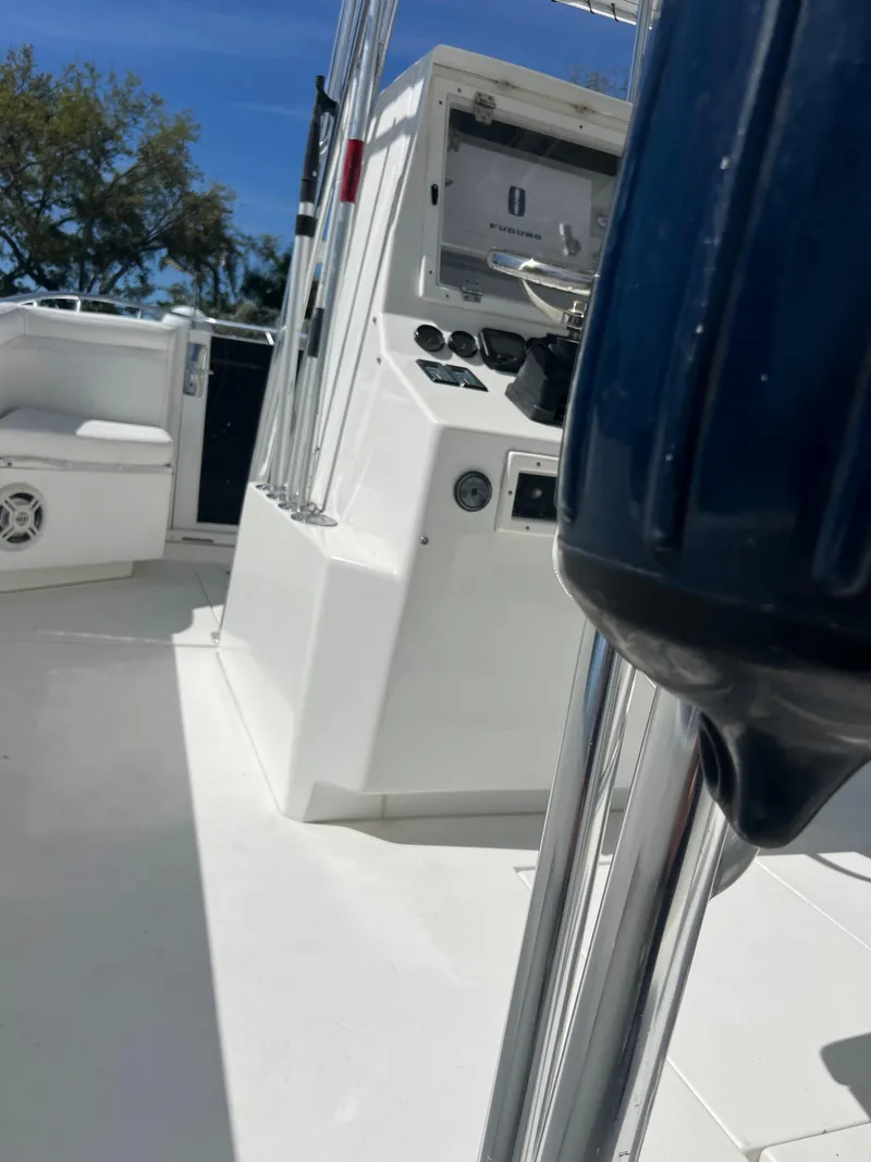 Slide: The Image of 1999 Contender 35 Center Console boat interior with forward cuddy, featuring control panel and seating. - 27