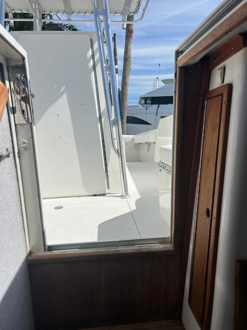 Slide: The Image of 1999 Contender 35 Center Console with forward cuddy, interior view, open hatch, and deck. - 37