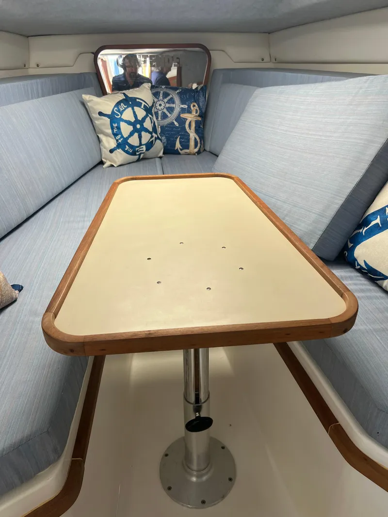 Slide: The Image of 1999 Contender 35 Center Console interior with forward cuddy, featuring nautical-themed cushions. - 38