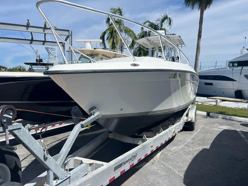 Slide: The Image of 1999 Contender 35 Center Console boat on trailer, parked outdoors. - 4