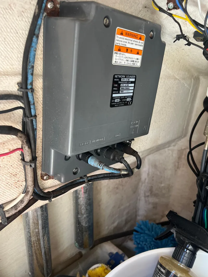 Slide: The Image of Electrical box inside 1999 Contender 35 Center Console boat, showing wiring and components. - 46