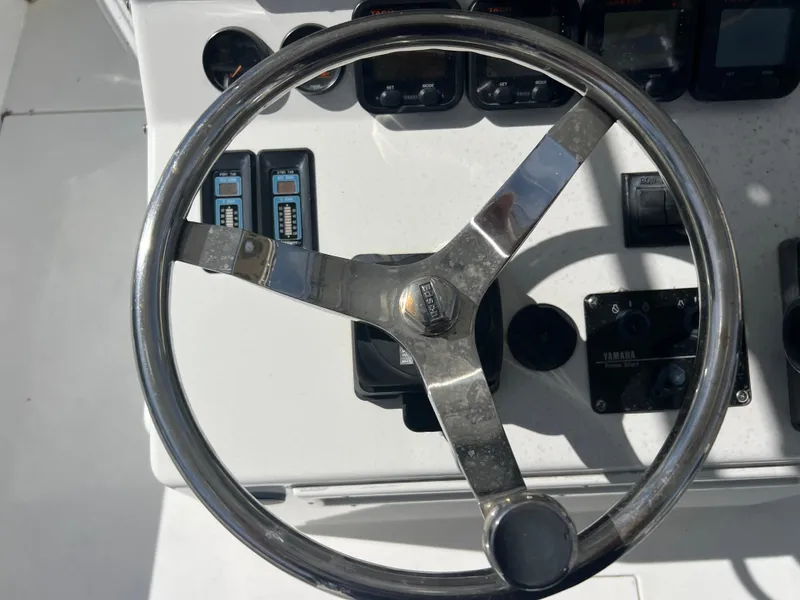 Slide: The Image of Steering wheel of a 1999 Contender 35 Center Console boat with forward cuddy. - 49