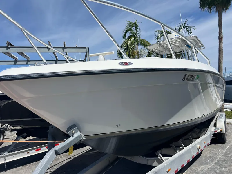 Slide: The Image of 1999 Contender 35 Center Console boat with forward cuddy on trailer, palm trees in background. - 5