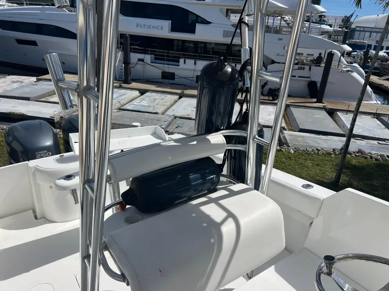 Slide: The Image of 1999 Contender 35 Center Console with forward cuddy, docked near luxury yachts. - 7