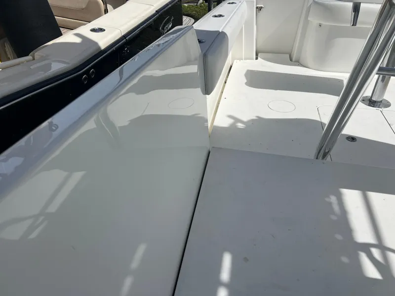 Slide: The Image of 1999 Contender 35 Center Console boat interior with forward cuddy, white deck, and seating. - 8