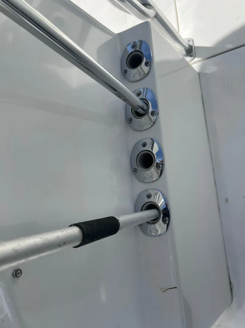 Slide: The Image of 1999 Contender 35 Center Console rod holders, stainless steel finish, close-up view. - 9