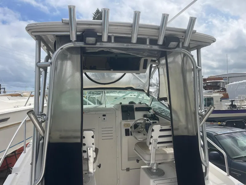 Slide: The Image of 2005 Robalo R235 Walkaround boat cockpit with steering wheel and seating. - 10