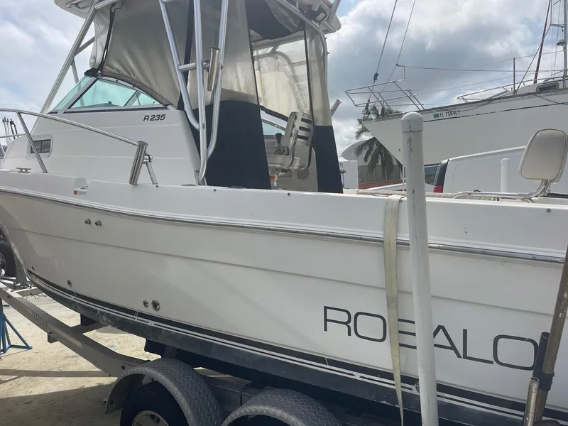 Slide: The Image of 2005 Robalo R235 Walkaround boat on trailer, side view, white exterior. - 3