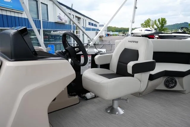 Slide: The Image of 2025 Harris Breeze 210 boat interior with steering wheel and seating. - 10