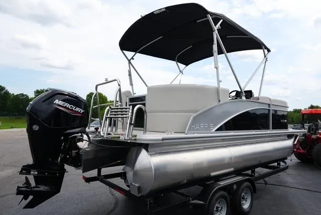 Slide: The Image of 2025 Harris Breeze 210 pontoon boat with Mercury outboard motor on trailer. - 5
