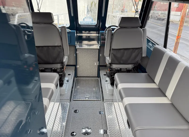 Slide: The Image of Interior of 2025 Hewescraft 270 Alaskan ET HT boat, featuring seating and helm area. - 3