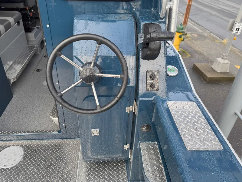 Slide: The Image of Steering wheel of 2025 Hewescraft 270 Alaskan ET HT boat, featuring a rugged design. - 8