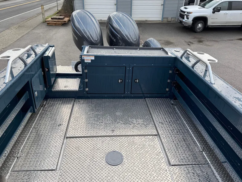 Slide: The Image of 2025 Hewescraft 270 Alaskan ET HT boat deck with dual outboard motors. - 9