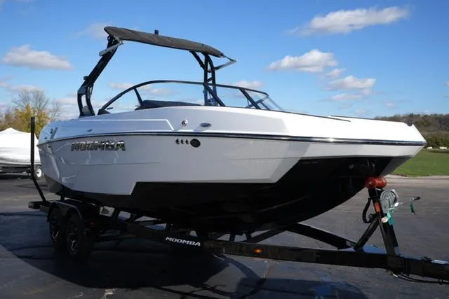 Slide: The Image of 2025 Moomba Max boat on trailer, sleek design, white exterior, sunny day. - 14