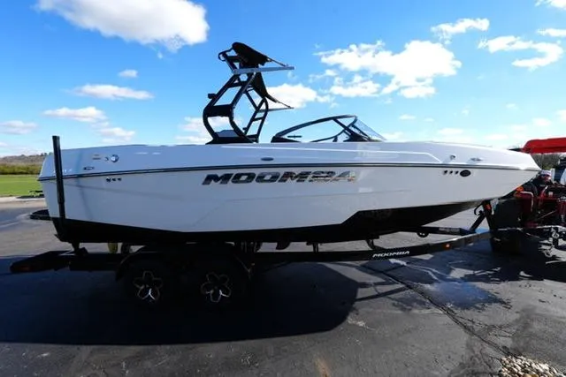 Slide: The Image of 2025 Moomba Max boat on trailer under blue sky. - 15