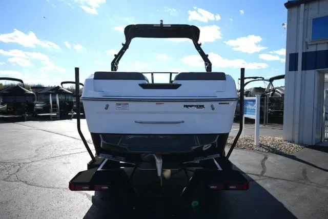 Slide: The Image of 2025 Moomba Max boat rear view in a sunny outdoor setting. - 16