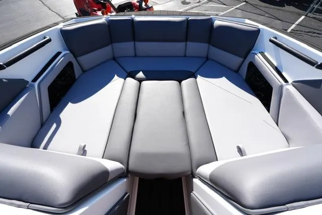 Slide: The Image of 2025 Moomba Max boat interior with spacious, cushioned seating in a sleek design. - 17