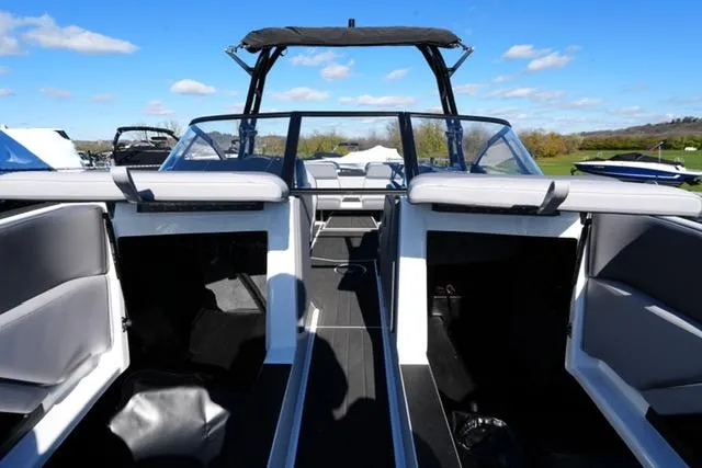 Slide: The Image of 2025 Moomba Max boat interior with open seating and sleek design. - 19