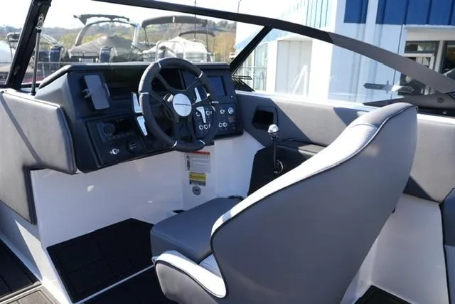 Slide: The Image of 2025 Moomba Max boat interior with steering wheel and captain's seat. - 20