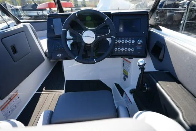 Slide: The Image of 2025 Moomba Max boat cockpit with steering wheel and control panel. - 21