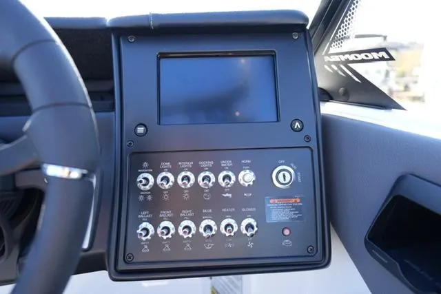 Slide: The Image of 2025 Moomba Max boat dashboard with control panel and display screen. - 22
