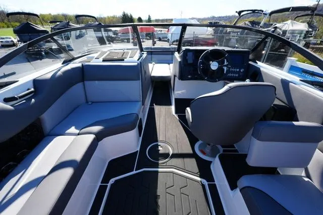 Slide: The Image of 2025 Moomba Max boat interior with modern seating and steering console. - 23
