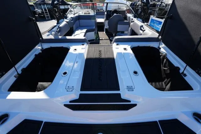 Slide: The Image of 2025 Moomba Max boat interior with open storage compartments and seating area. - 25