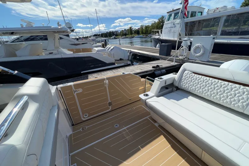 Slide: The Image of Luxurious 2026 Regal LX43 yacht interior with elegant seating at a marina. - 10