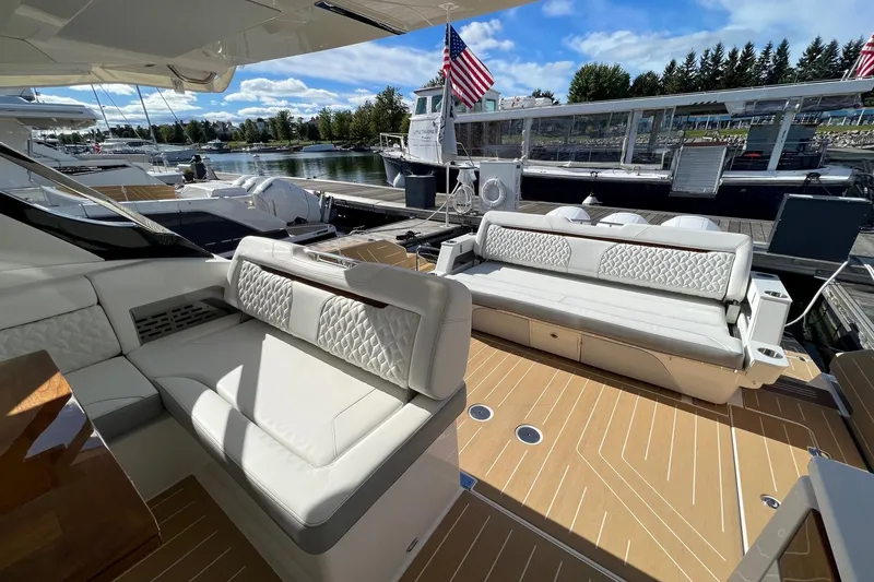 Slide: The Image of Luxurious 2026 Regal LX43 yacht interior with elegant seating and wooden deck. - 11