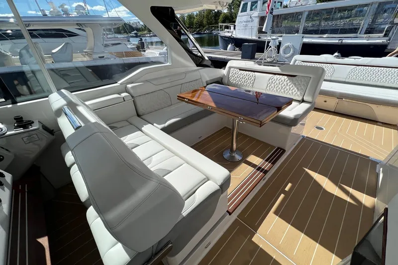 Slide: The Image of Luxurious interior of 2026 Regal LX43 yacht with elegant seating and wooden table. - 13