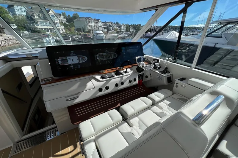 Slide: The Image of Luxurious 2026 Regal LX43 yacht cockpit with modern controls and waterfront view. - 14