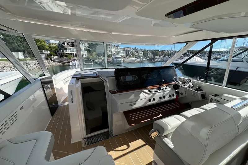 Slide: The Image of Luxurious 2026 Regal LX43 yacht interior with modern helm and marina view. - 17