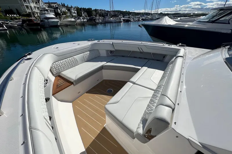 Slide: The Image of Luxurious 2026 Regal LX43 boat interior with elegant seating in a marina setting. - 18