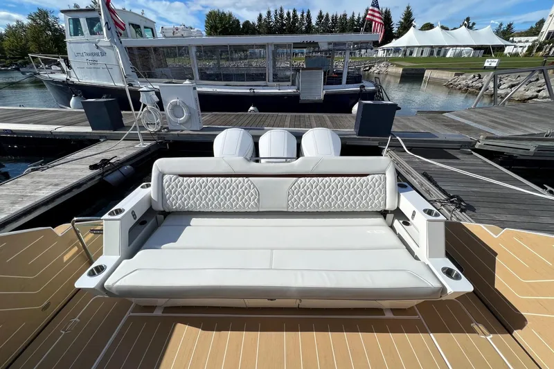 Slide: The Image of 2026 Regal LX43 boat with luxurious seating at a marina dock. - 8