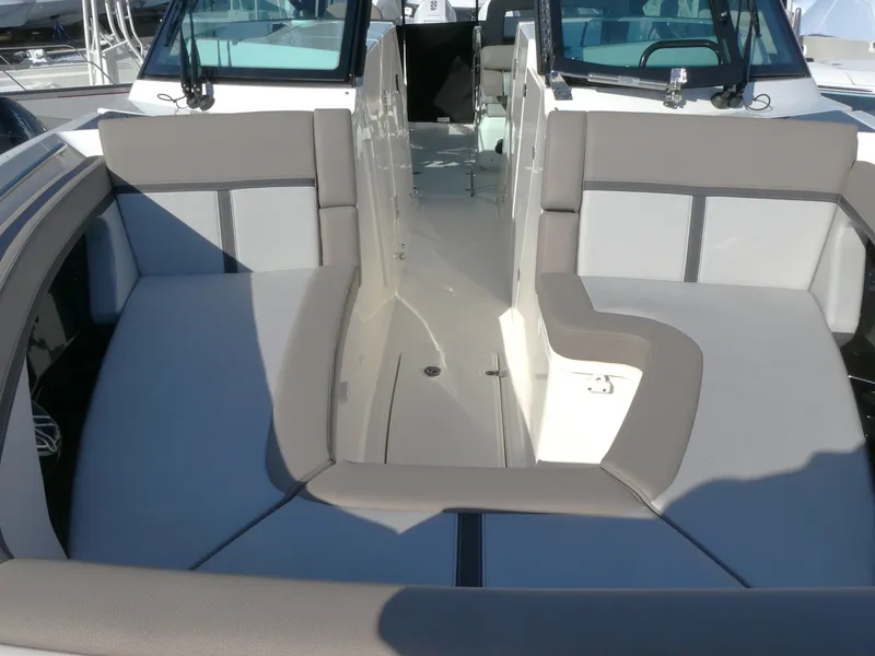 Slide: The Image of 2025 Boston Whaler 330 Vantage boat interior with cushioned seating and modern design. - 14