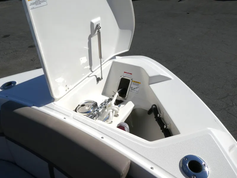 Slide: The Image of Boston Whaler 330 Vantage 2025 boat storage compartment with open lid and equipment. - 15