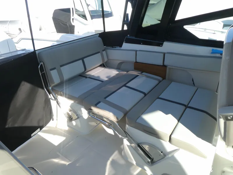 Slide: The Image of 2025 Boston Whaler 330 Vantage interior seating area with modern design and comfortable upholstery. - 8