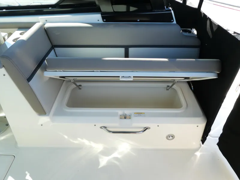 Slide: The Image of 2025 Boston Whaler 330 Vantage boat seat with storage compartment open. - 9