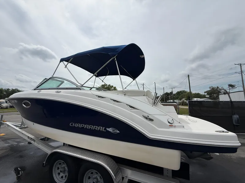 Slide: The Image of 2015 Chaparral Sunesta 224 boat with blue canopy on a trailer. - 10