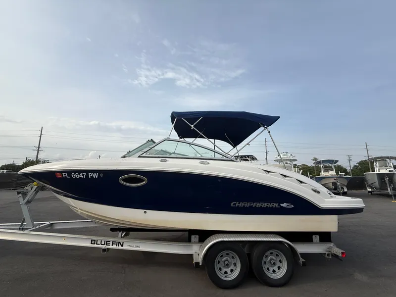 Slide: The Image of 2015 Chaparral Sunesta 224 boat on trailer with blue canopy. - 11
